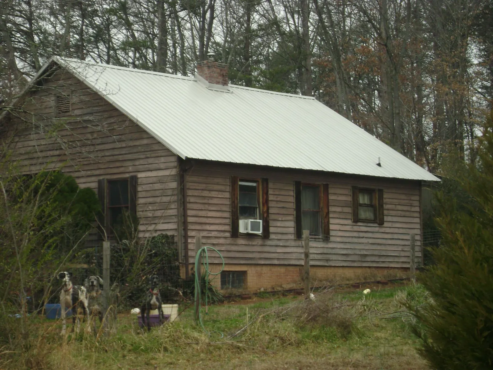 White metal roof on an old wood sided farmhouse, from a Metal Roof Installation job in Bristol